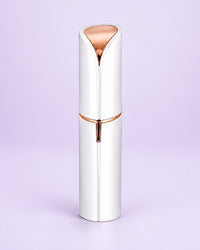 White facial hair remover with its cap on, shaped like a lipstick