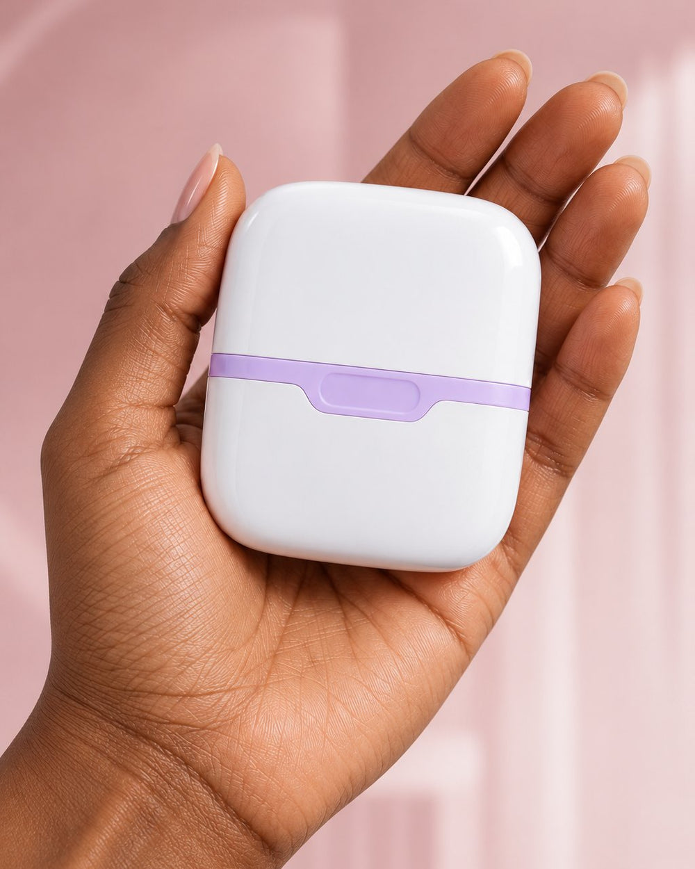 The capped double ice roller resting in an open palm