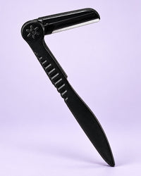 Black folding brow razor shown open