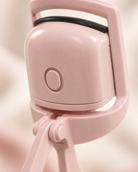 Close-up of the curler's heated clamp and its single power button