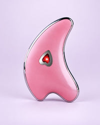 Pink dolphin-shaped gua sha with a heart light in the middle