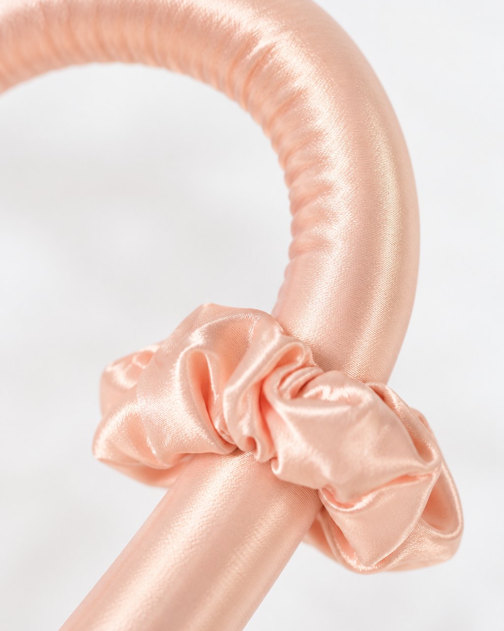Close-up of the rod's smooth, shiny cover and a matching scrunchie