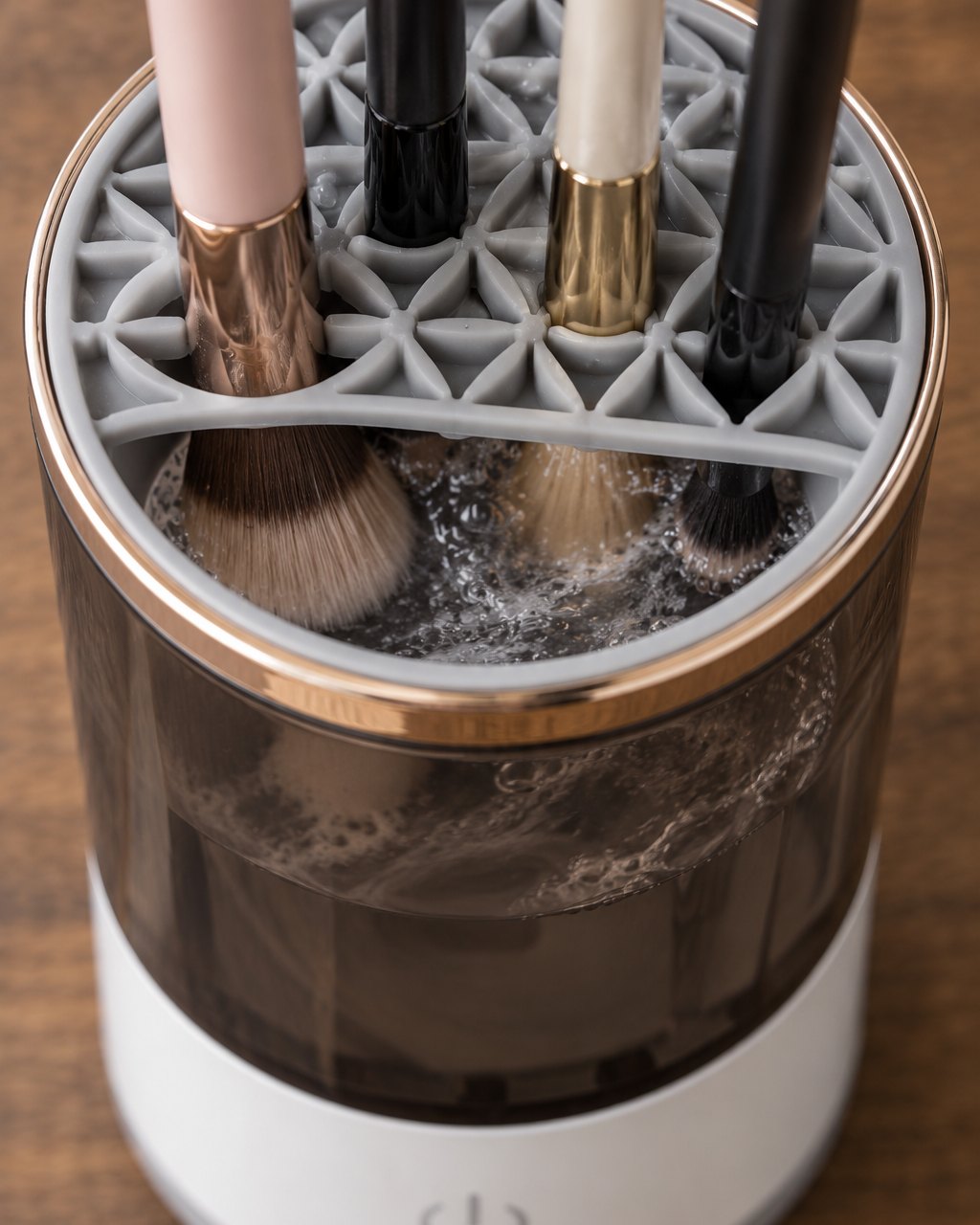 Close-up of the holder lid with several brushes slotted head-down into the jar