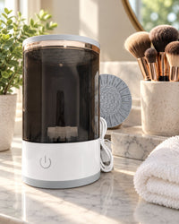Brush cleaner on a bathroom vanity next to a cup of clean makeup brushes
