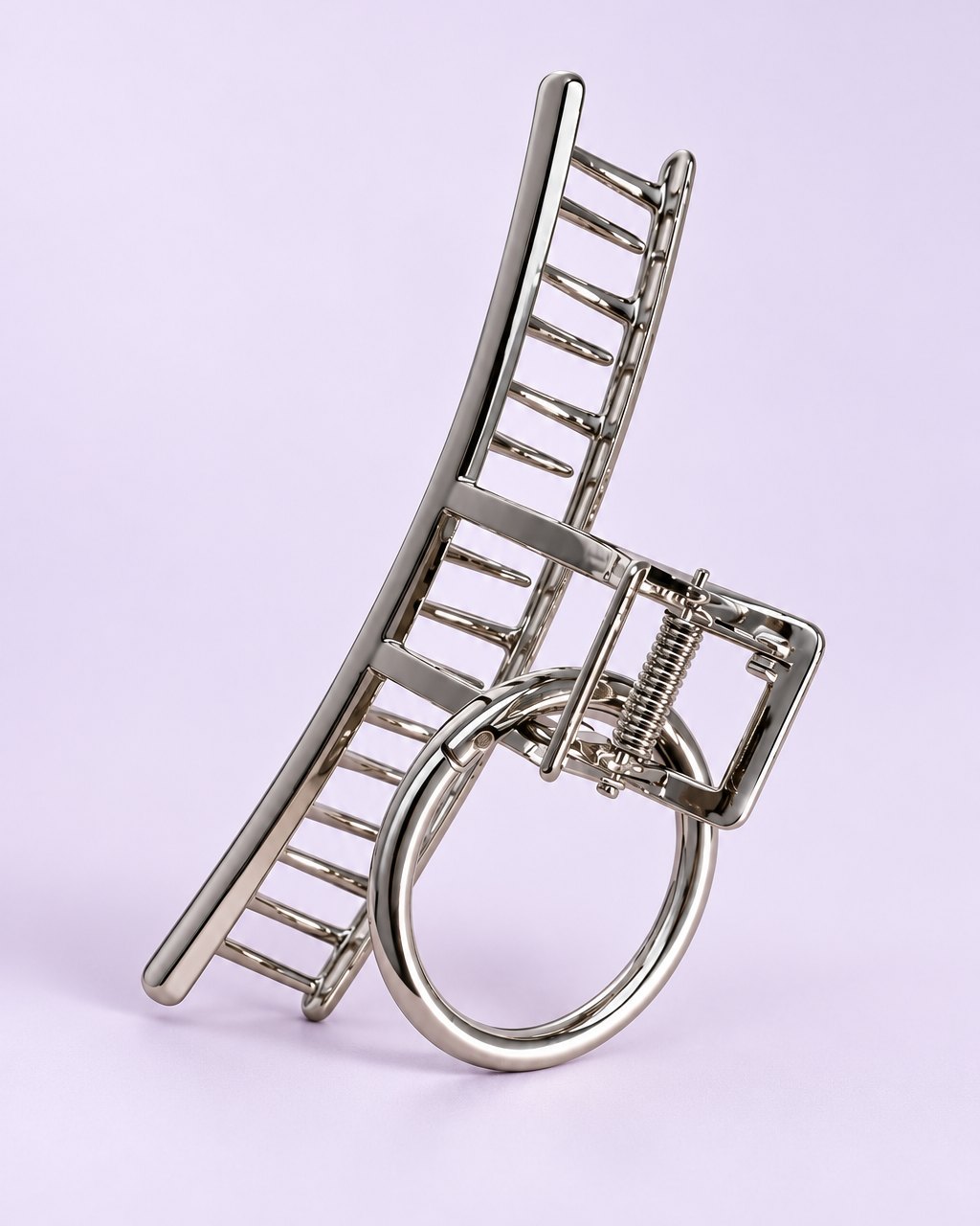 Large silver metal claw clip with an open sculptural design