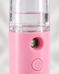 Close-up of the mister's spray window, button and clear tank
