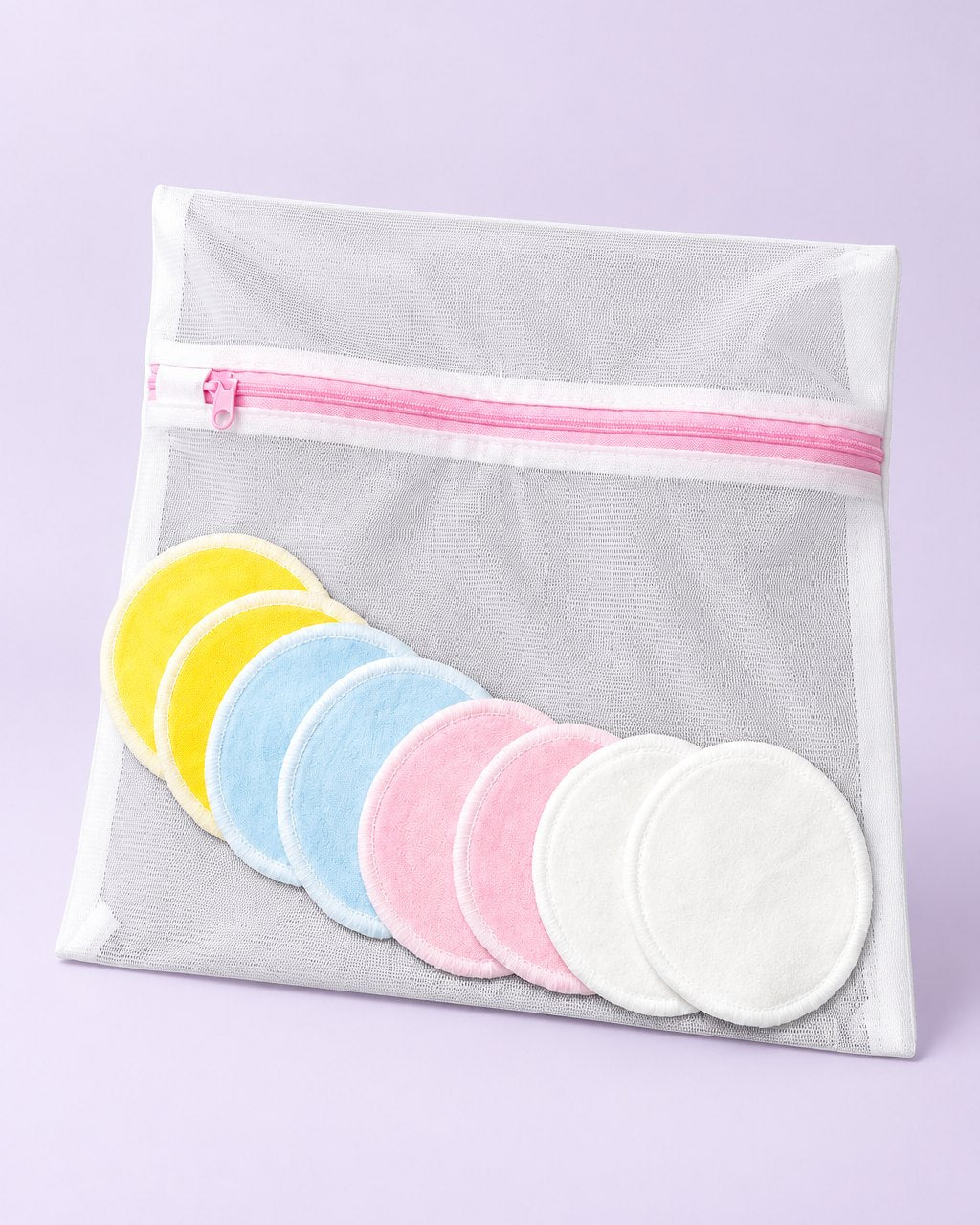 Eight soft reusable face rounds in four pastel colours beside a mesh wash bag