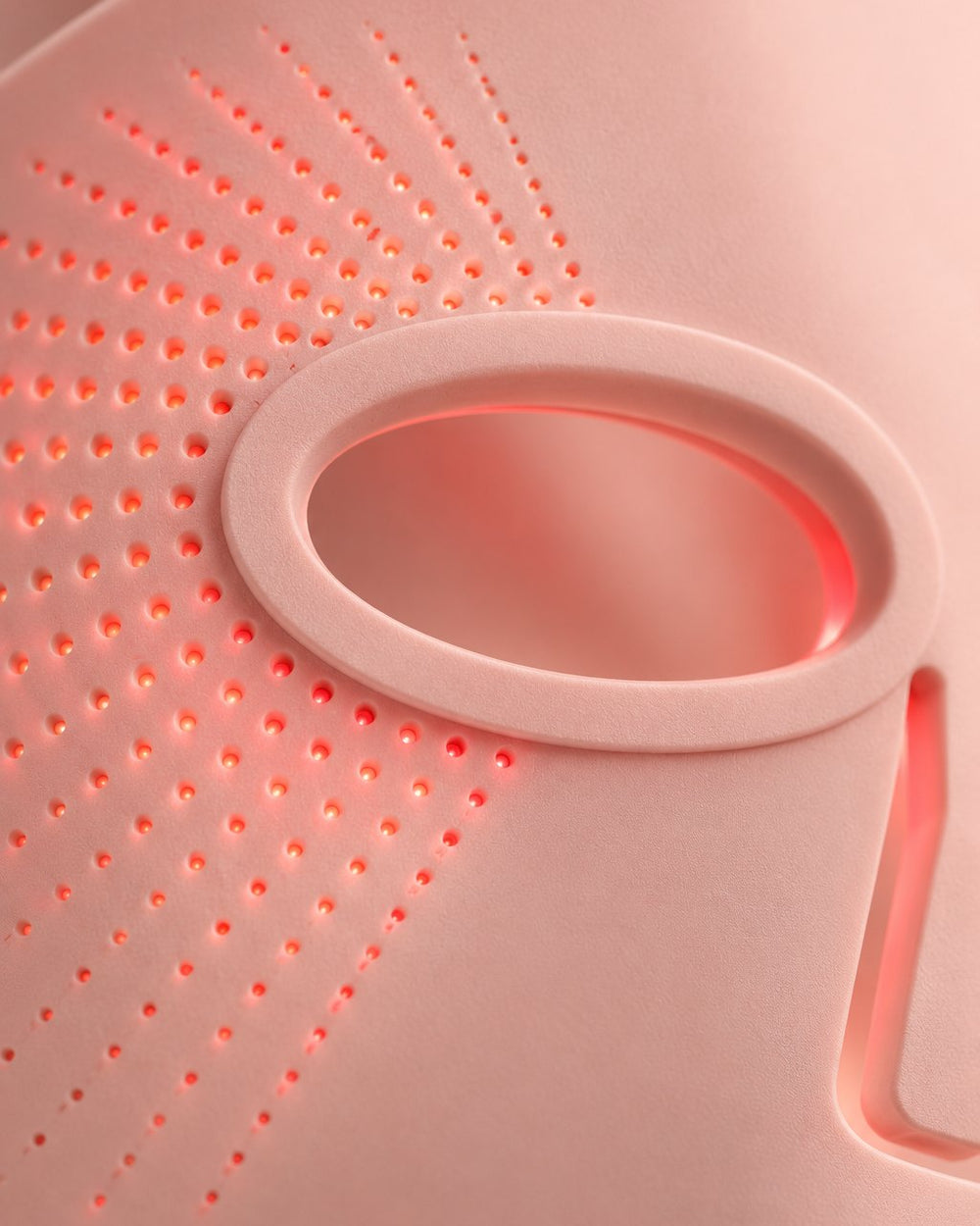 Close-up of the soft pink silicone and tiny LED dots beside an eye opening