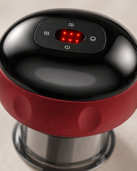 Close-up of the cupping massager's top with its glowing red screen and button icons