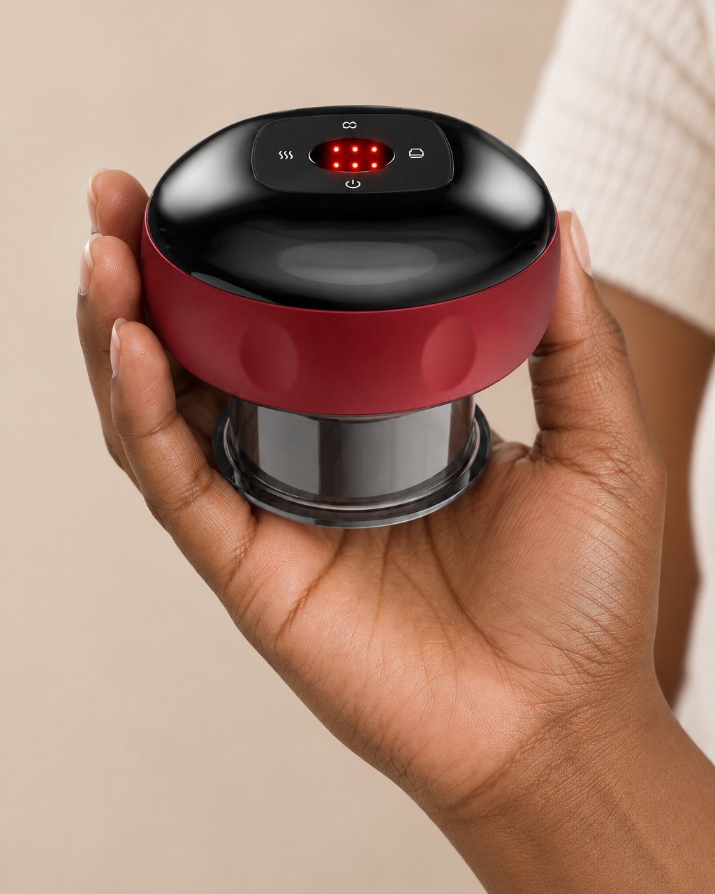 The cupping massager held in one hand, about the size of a palm