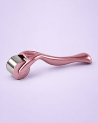 Rose gold ice roller with a stainless steel roller head
