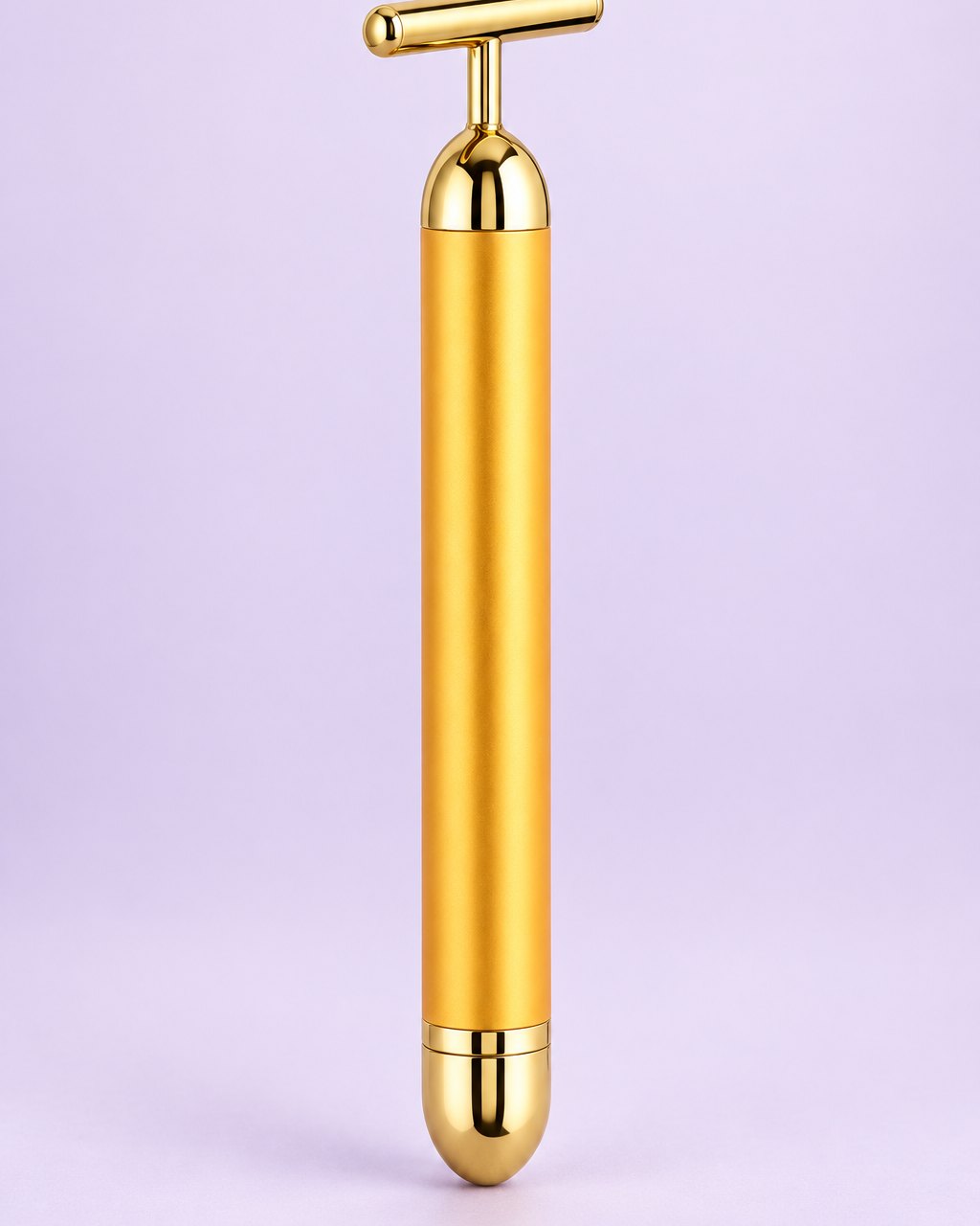 Gold-tone vibrating beauty bar with a T-shaped head, standing